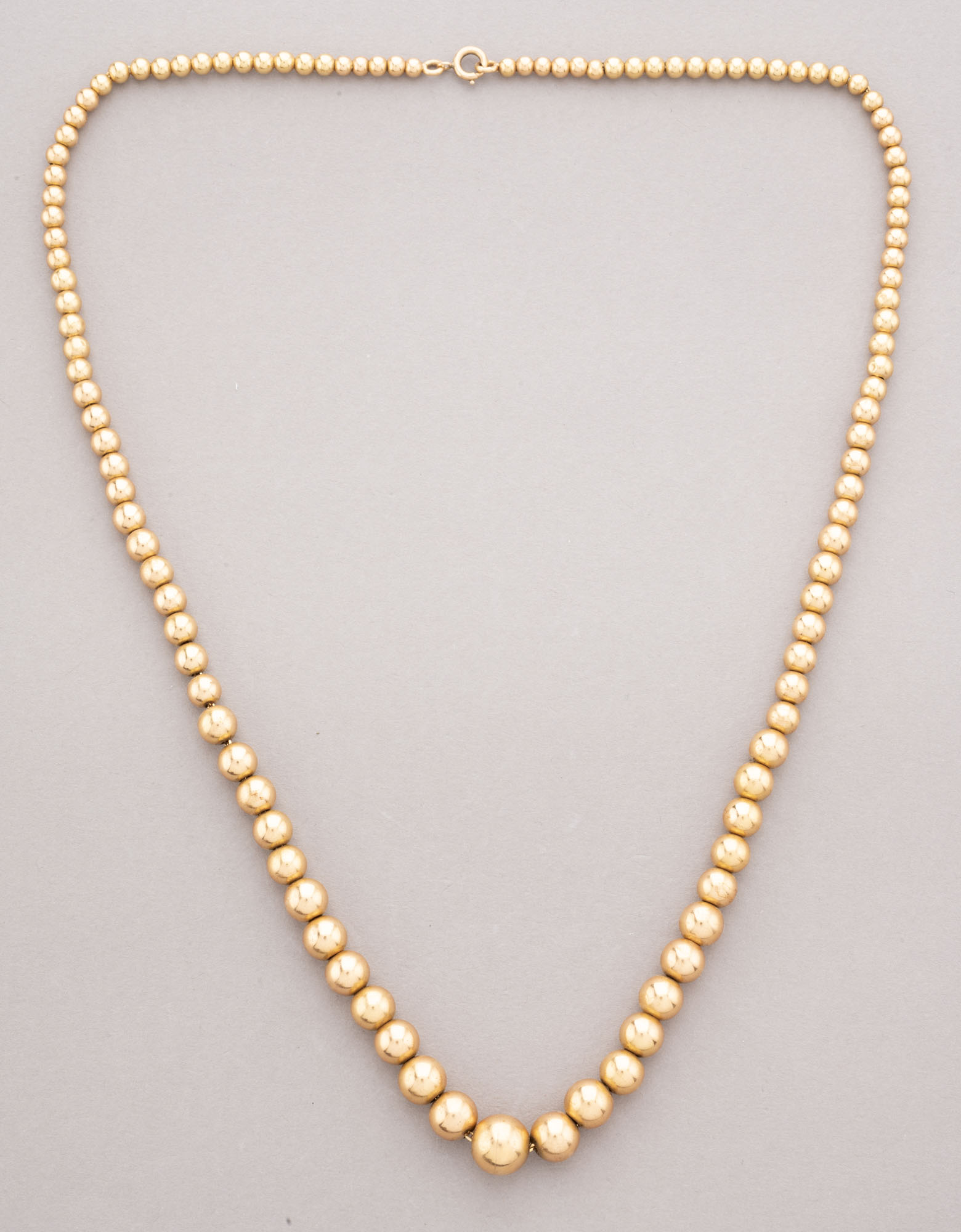 COLLIER boules d’Aix en or jaune 750 millièmes. Long. 42…